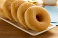 Plate with of tasty sweet traditional donuts close up