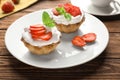 Plate with tasty tartlets on wooden table Royalty Free Stock Photo