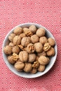 Plate with tasty walnuts on color napkin Royalty Free Stock Photo