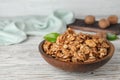 Plate with tasty walnuts on wooden table. Royalty Free Stock Photo