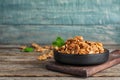 Plate with tasty walnuts on wooden table. Royalty Free Stock Photo