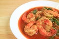 Plate of Thai Style Spicy Stir Fried Prawns with Holy Basil Served on Wooden Table