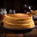 Plate of thin pancakes, close up on a wooden background