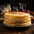 Plate of thin pancakes, close up on a wooden background