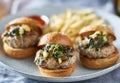 Plate of three turkey burger sliders with fries