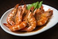 plate of tiger shrimp prawns drenched in tangy sauce