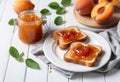A plate of toast with apricot jam on a rustic wooden table Royalty Free Stock Photo