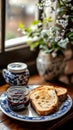 Plate of toast with jam and a vase of flowers on a table Royalty Free Stock Photo