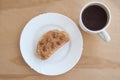 A plate with toasted bread and peanut butter and a cup of coffee on the wooden table. Top view Royalty Free Stock Photo