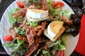 A plate of warm goat cheese salad