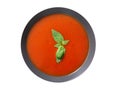 Plate of tomato soup with basil isolated on a white background Royalty Free Stock Photo