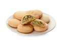 Plate with traditional cookies for Islamic holidays on white. Eid Mubarak