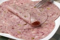 Plate with traditional Dutch zure zult, headcheese, slices