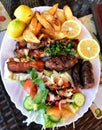 Plate of traditional Greek meat souvlaki with potato and salad Royalty Free Stock Photo