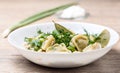 plate of traditional Russian dumplings sprinkled with herbs on wooden table Royalty Free Stock Photo