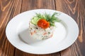 Plate of traditionsl russian salad Olivier on wooden table Royalty Free Stock Photo