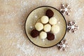 Plate with unbaked coconut balls and chocolate truffles Royalty Free Stock Photo