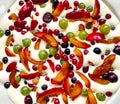 Plate of uncooked clafouti with berries and fruits