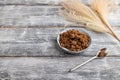 Plate with unrefined cane sugar on gray wooden. side view, copy space Royalty Free Stock Photo