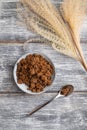 Plate with unrefined cane sugar on gray wooden. top view, close up Royalty Free Stock Photo