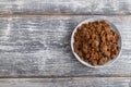 Plate with unrefined cane sugar on gray wooden. top view, copy space Royalty Free Stock Photo