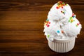 Plate of vanilla and and chocolate ice cream scoop swith sprinkles and waffle cones on wooden background with copy space Royalty Free Stock Photo