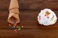 Plate of vanilla ice cream scoop swith sprinkles and waffle cones on wooden background with copy space Royalty Free Stock Photo