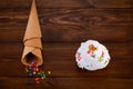 Plate of vanilla ice cream scoop swith sprinkles and waffle cones on wooden background with copy space Royalty Free Stock Photo