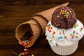 Plate of vanillaand and chocolate ice cream scoop swith sprinkles and waffle cones on wooden background with copy space Royalty Free Stock Photo