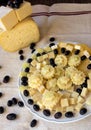 Plate with various cheeses, melon and grapes