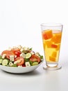 Plate of vegetable salad and glass of fruit cocktail.