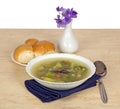 Plate of vegetable soup and violets