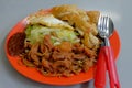 A plate of vegetarian noodles, served with assorted vegetables, egg and fried beancurd (tofu) skin