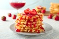 Plate with waffles and strawberry jam on wooden table Royalty Free Stock Photo