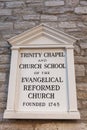 Plate on the wall of the historic complex in Frederick which includes Trinity chapel