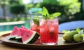 Plate of Watermelon and Limeade Next to Watermelon Pitcher Royalty Free Stock Photo