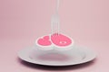 a plate on which a piece of meat is pricked on a fork on a pink background. 3D render