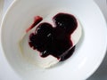 Plate of white ice cream drenched jam Royalty Free Stock Photo