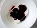 Plate of white ice cream drenched jam Royalty Free Stock Photo