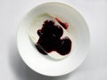Plate of white ice cream drenched jam Royalty Free Stock Photo