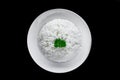 Plate with white rice, serving for Vietnamese dishes on black background Royalty Free Stock Photo