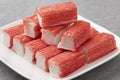 Plate with whole and half Surimi sticks close up