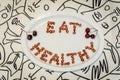 Plate with words Eat Healthy made of cherry kernels