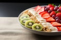 Plate with yogurt, muesli, kiwi, strawberries, and banana a wholesome breakfast