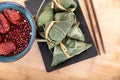 A plate of zongzi for the Dragon Boat Festival and a large bowl of red dates and red beans on a cutting board Royalty Free Stock Photo