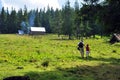 Plateau and forest in mountains, hut, walking father and daughter