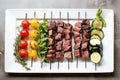 plated assortment of uncooked lamb skewers