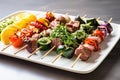 plated assortment of uncooked lamb skewers