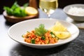 plated chana masala with a lemon wedge side