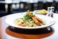 plated couscous salad with grilled chicken strips